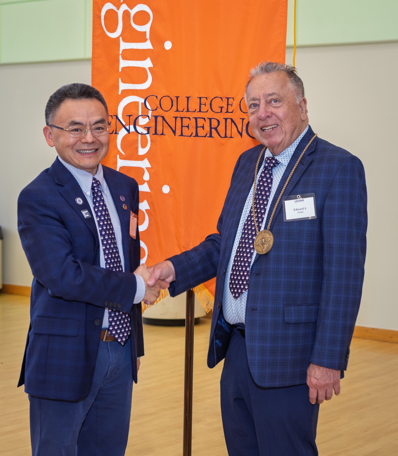 Ed receiving Distinguished Engineer award and shaking hands with Dean Zhau
